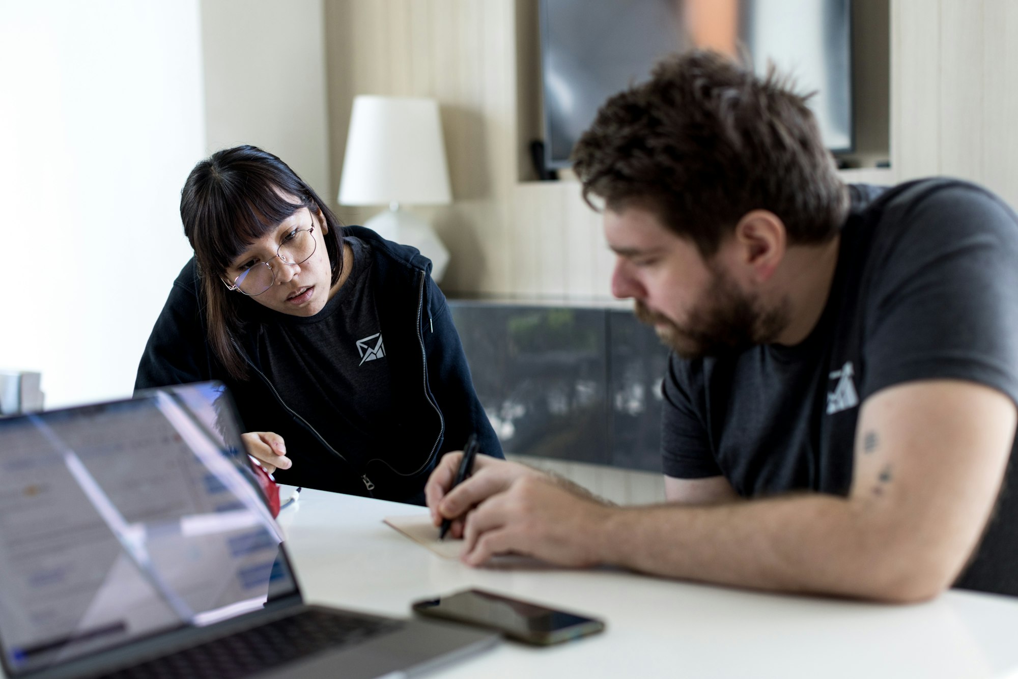 Customer support professional in a training session with a notebook