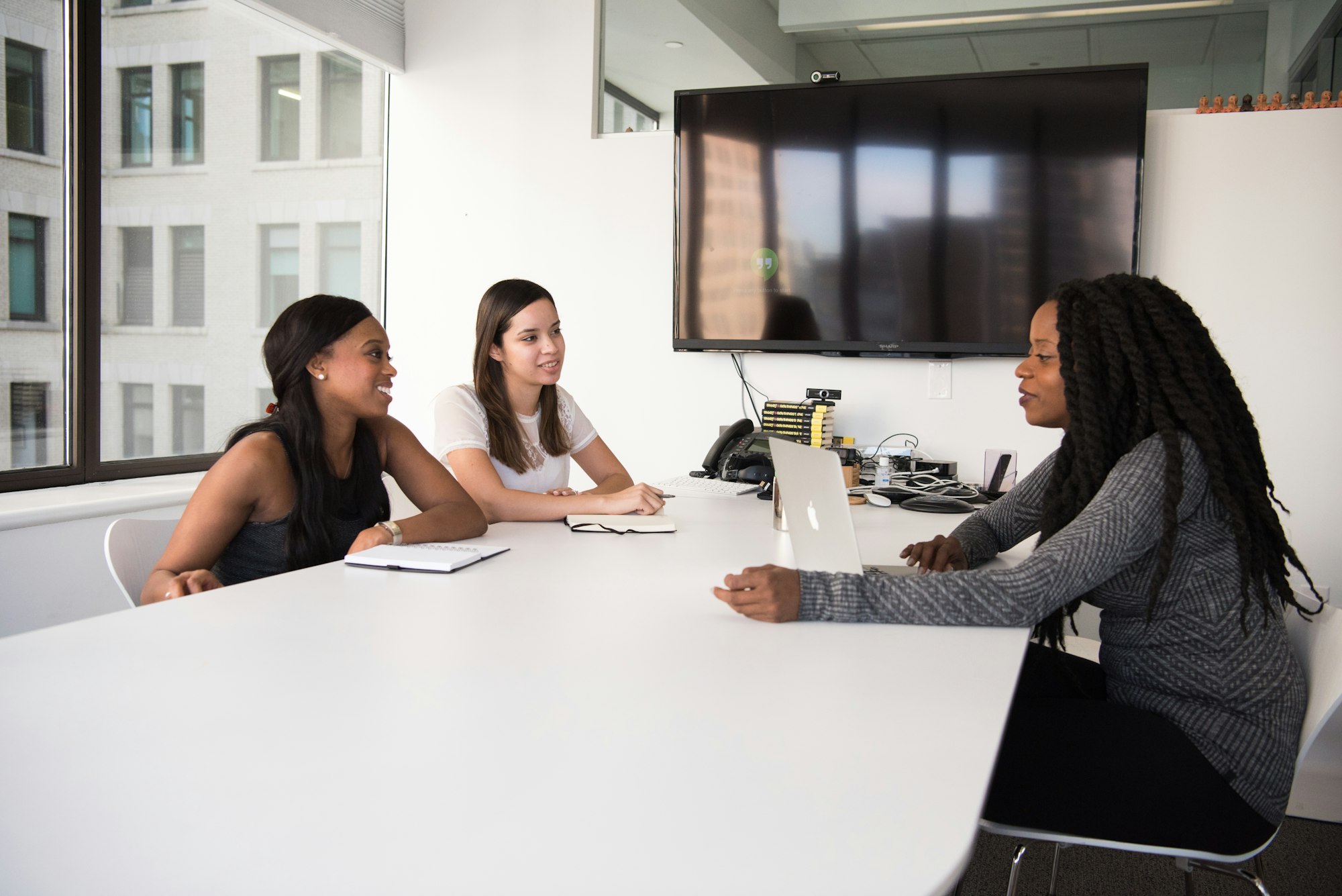 Hiring manager reviewing notes during an interview in an office
