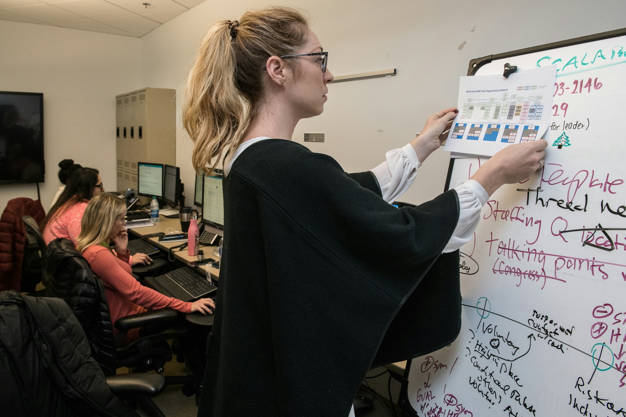 Contact centre team leader reviewing performance dashboards with an agent