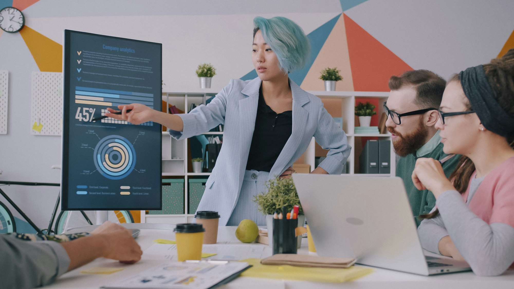 Professionals reviewing customer experience metrics on a screen