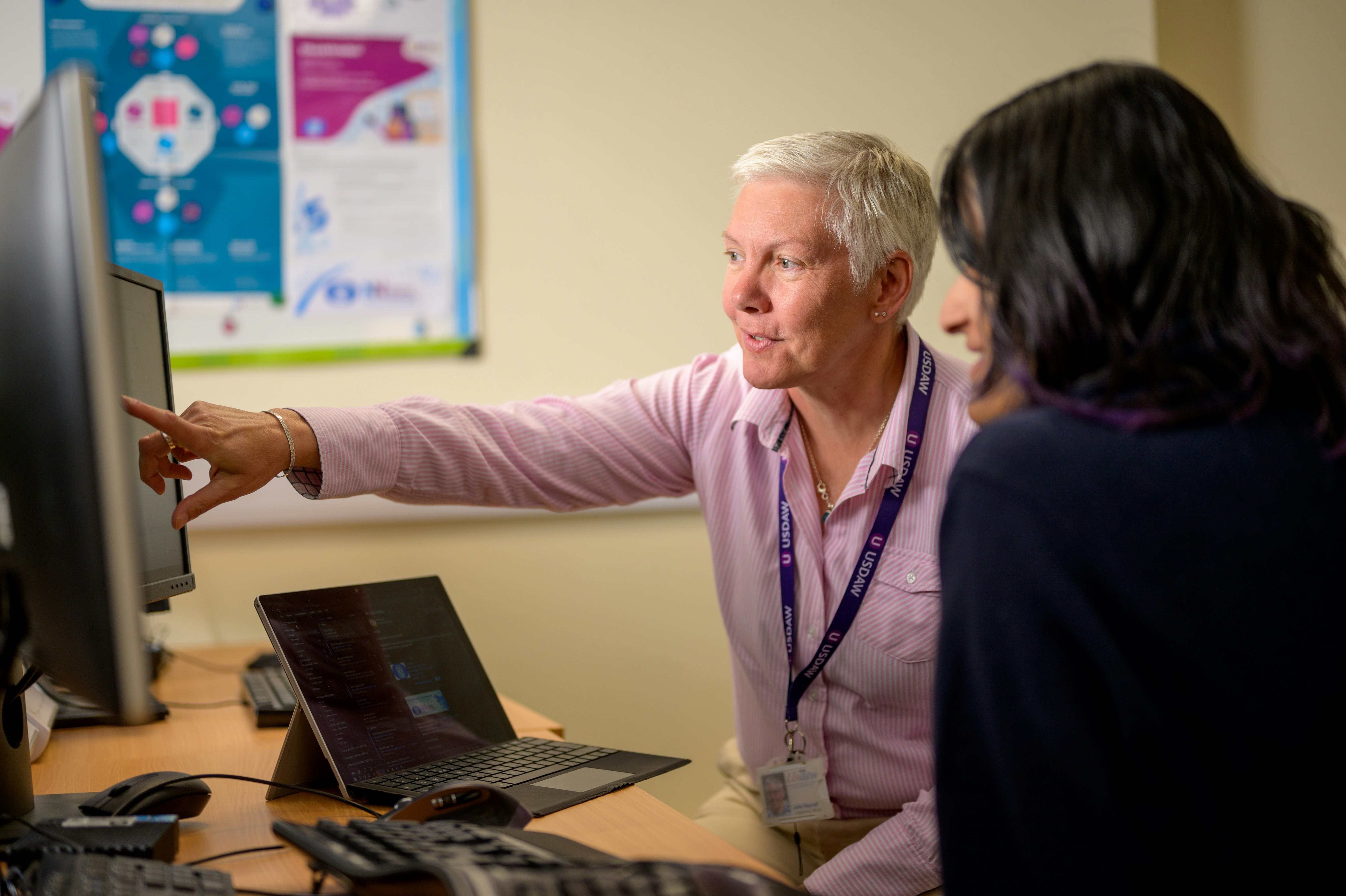 Customer service manager reviewing performance data with a team member