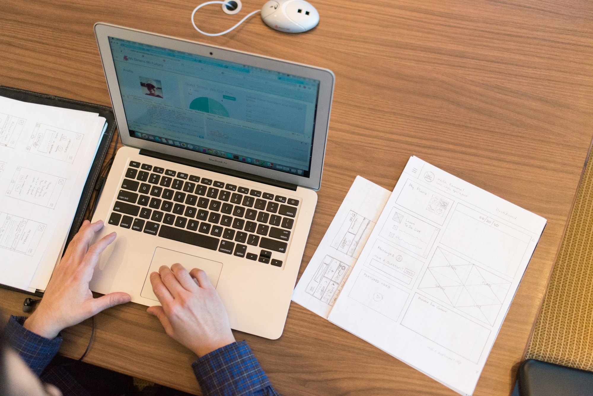 Professional completing an online assessment on a laptop with notes beside them
