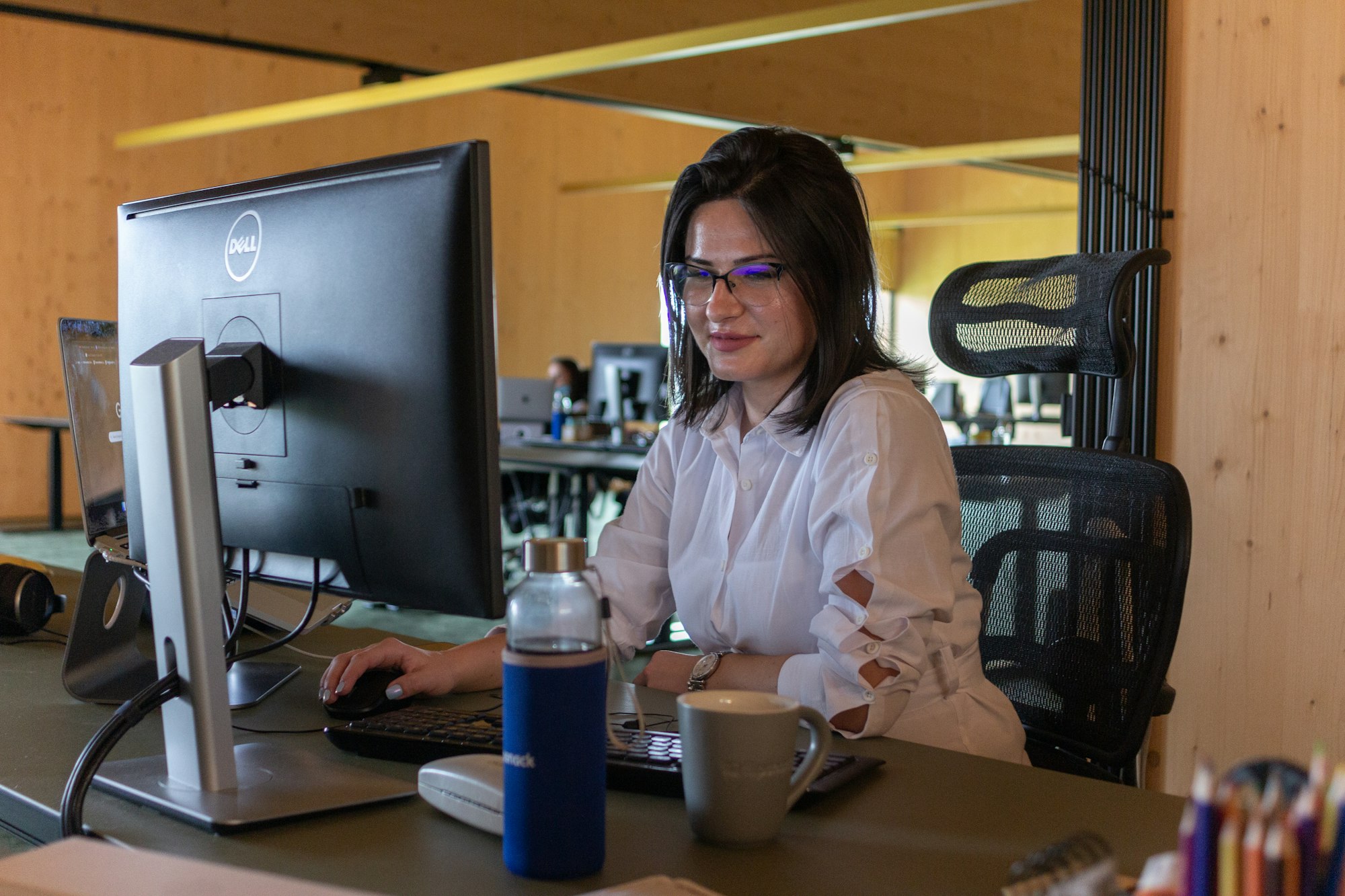 Contact centre advisor wearing a headset during a monitored call