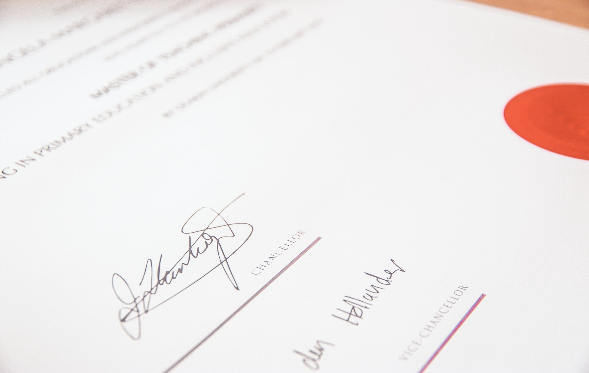 Professional reviewing study notes and a certificate document at a desk