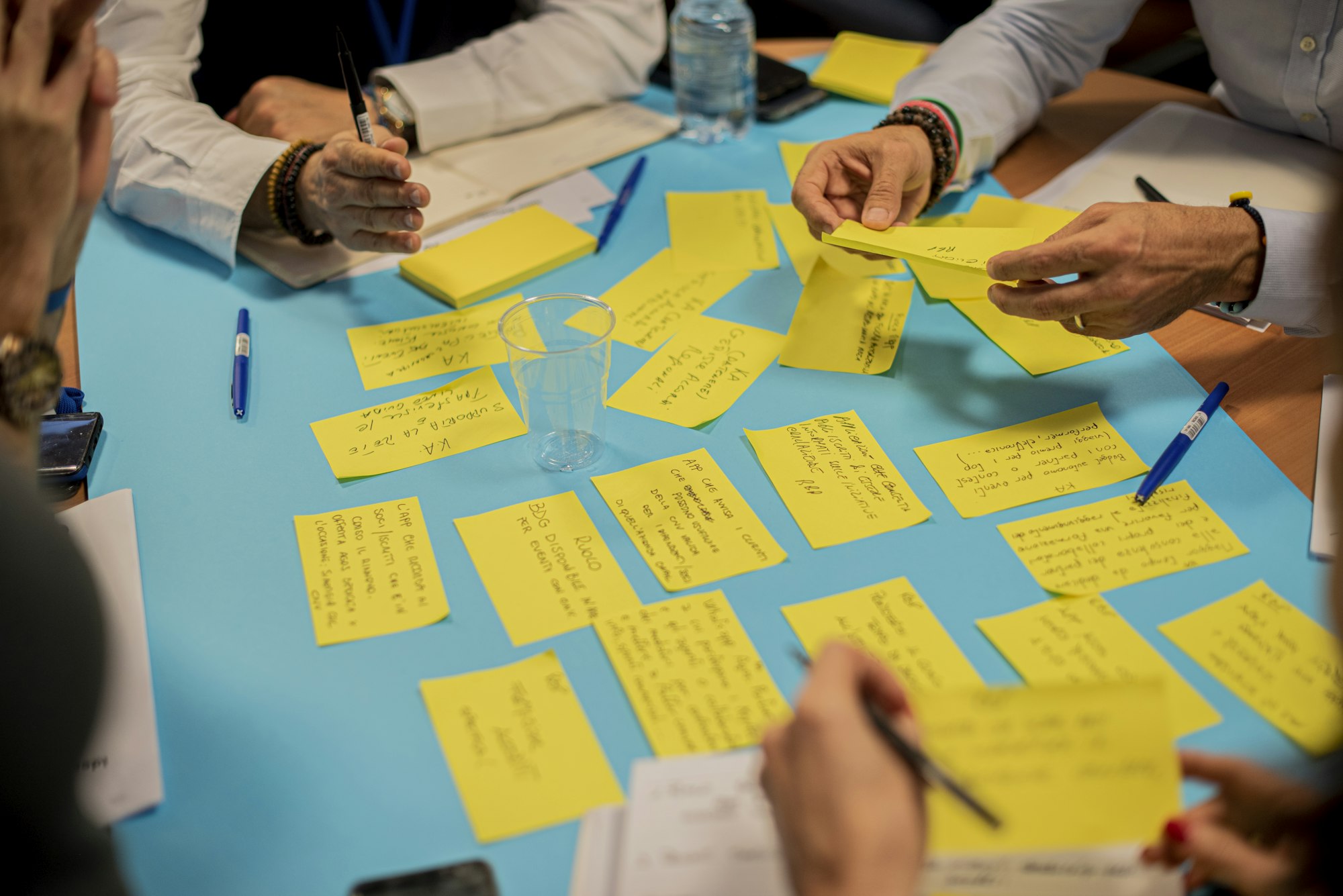 Professionals in a workshop reviewing a customer journey on a whiteboard