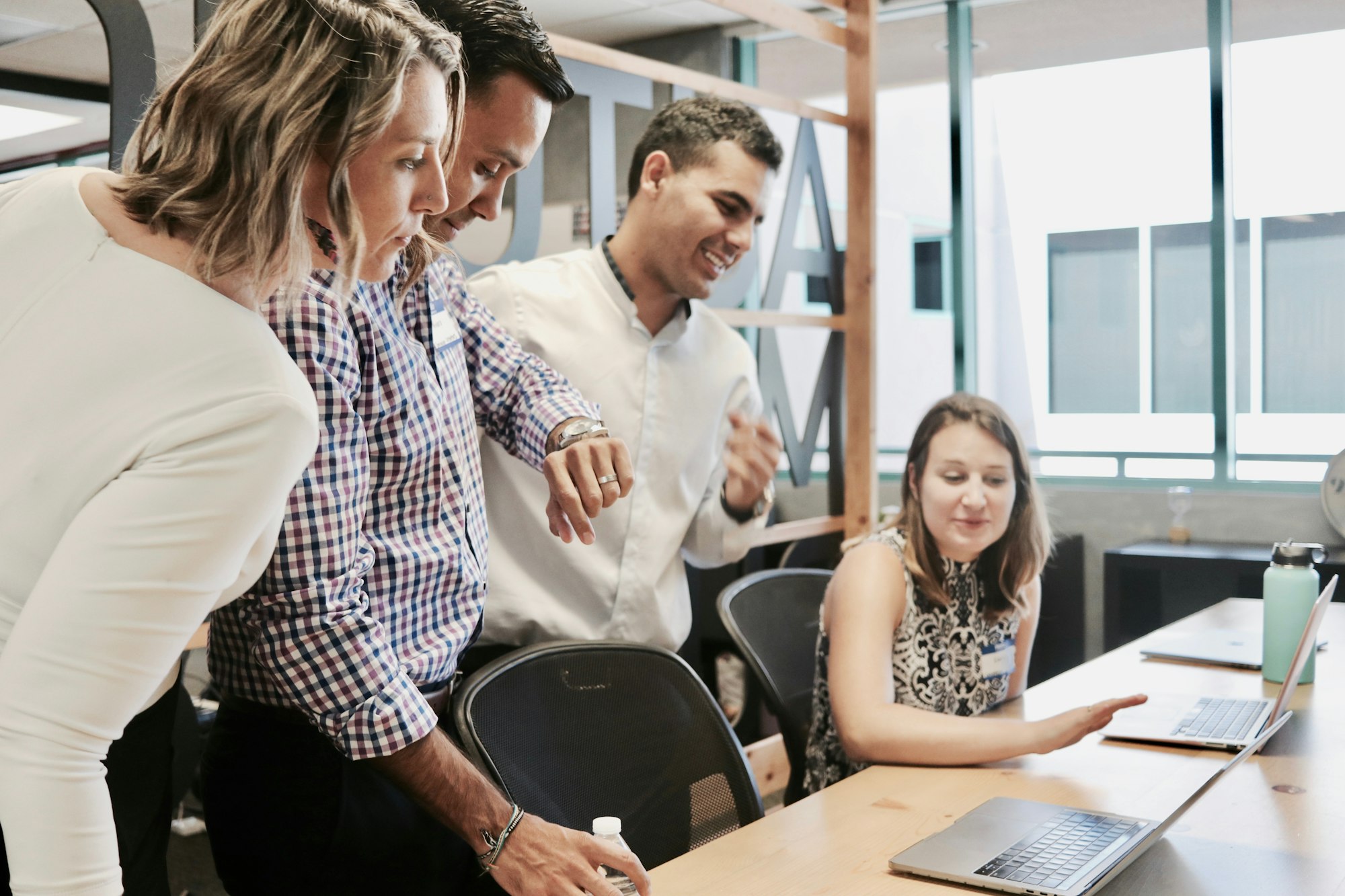 Customer service team leader facilitating a team discussion in an office meeting room